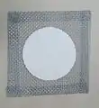 A 5-inch (125&nbsp;mm) square of wire gauze with ceramic center