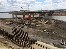 Berms were used for construction of two steel bridges carrying Anthony Henday Drive over the North Saskatchewan River in northeast Edmonton, first on the river's south bank, then the north bank seen here in 2014.  The bridges carry three lanes northbound and four lanes southbound.