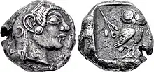Both sides of a silver coin. One side shows a head in profile; the other an owl.