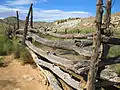 The rear portion of the wooden fence surrounding the cabin