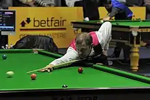 Hawkins holding the cue in his left hand for a normal shot