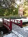 Asian style bridge with the water tower in the background.