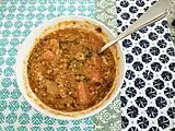 Bowl of lentil soup with green and red lentils.