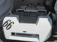 Front view of an open-top sportscar with no headlights