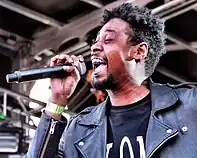 Photo of a man singing into a microphone