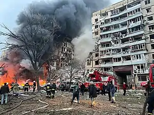 Firefighters putting out a fire at a residential building on Sobornyi District's Naberezhna Peremohy St&nbsp;[uk], 118, on 14 January 2023 after it was destroyed by a Russian Kh-22 missile