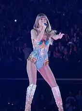 Swift singing onstage dressed in a sparkling bodysuite
