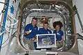 In honour of those affected by the 2011 Tōhoku earthquake and tsunami in Japan, Kondratyev (center), Nespoli & Coleman are pictured with origami cranes, which they folded to be placed in the HTV-2.