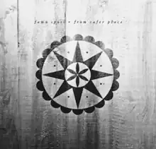 A series of concentric circles and stars in the middle, painted in black over a wall of white wood planks. The innermost star is six-pointed with long, narrow, rounded points, the middle star is eight-sided with isoceles triangle rays, and the outermost star has twenty half-circle-shaped rays. The band and album names are written above in all lowercase, on one line separated by a dot, in copperplate script.