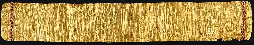 The Golden Letter. The mythical bird Hamsa is depicted on the left. Rows of rubies are set on both left and right. Damage from 1768 can be recognized at bottom-right.