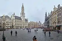 A cobblestone square surrounded by opulent multi-story buildings