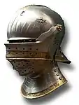 Late example of a German visored sallet (transitional to the close helm), c. 1495. The bevor and the brow-reinforce attach to the same pivot as the upper visor, and the tail at the rear of the helmet is much shorter than in earlier forms.