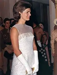 Jacqueline Kennedy wearing evening gloves at a state dinner in 1962.