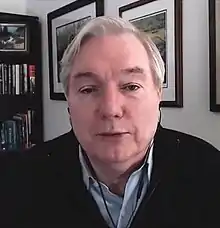 Image of Osterholm, with books and picture frames in the background