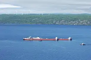 MV&nbsp;Roger Blough aground in Whitefish Bay with Prince Wind Farm in the background