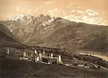 Traditional villages with mountains in background.