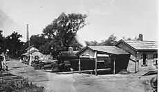 The no longer extant Pennsylvania Railroad depot in Rocky Hill, with the Delaware and Raritan Canal and the smokestack of the Power Station in the background