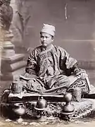 A Shan chief, sitting on a cusion
