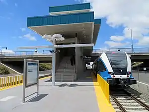 A railcar at a railway station in the center of a highway