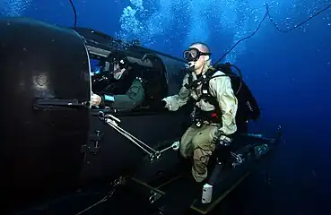 A Navy diver and special operator from SEAL Delivery Team 2 operate an SDV from the nuclear-powered guided-missile submarine USS&nbsp;Florida&nbsp;(SSGN-728)