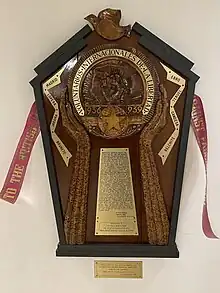 Spanish Civil War Memorial Manchester Central Library it shows  A relief carved pair of hands on a backboard with the inscription Voluntarios Internacionales de la Libertad dedicated to the men & women from the Greater Manchester area who fought against fascism in Spain