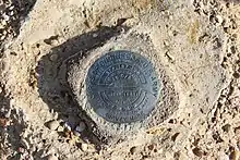 This is a brass survey marker for the Lake Wright Patman Dam installed in 1981 by the U.S. Army Corps of Engineers