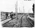 Railwaymen to work after a flooding of the Saint-Pierre River at west of the road to Saint-Paul-Coast in 1906