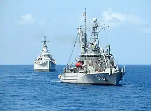 USNS&nbsp;Grasp&nbsp;(T-ARS-51), a Safeguard-class rescue and salvage ship, tows ex-USS&nbsp;Des Moines&nbsp;(CA-134) to the scrapyard in Texas