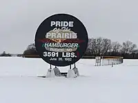 Sign made from the griddle used to cook the World's Largest Hamburger